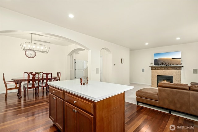 4915 NE 5th St, Renton, WA 98059 - kitchen with dark wood finished floors, a chandelier, a kitchen island, a fireplace, and recessed lighting