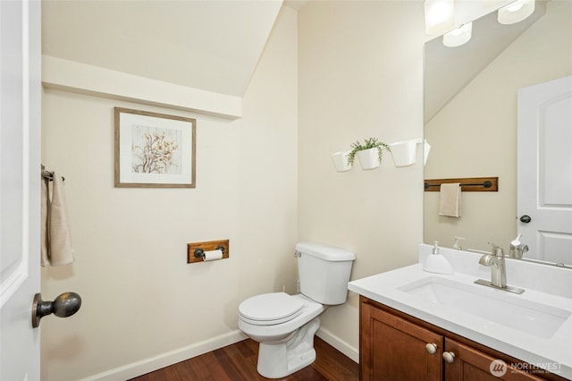 4915 NE 5th St, Renton, WA 98059 - bathroom featuring wood finished floors, baseboards, vanity, toilet, and vaulted ceiling