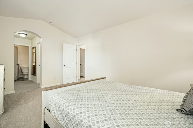 4915 NE 5th St, Renton, WA 98059 - bedroom with arched walkways, vaulted ceiling, light carpet, baseboards, and ensuite bathroom