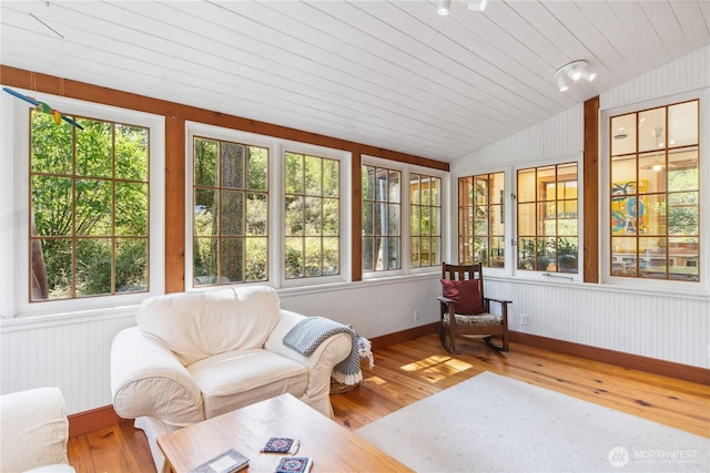 3422 Copper St, Port Townsend, WA 98368 - sunroom with hardwood / wood-style flooring, lofted ceiling, a wooden deck, baseboards, and wooden walls