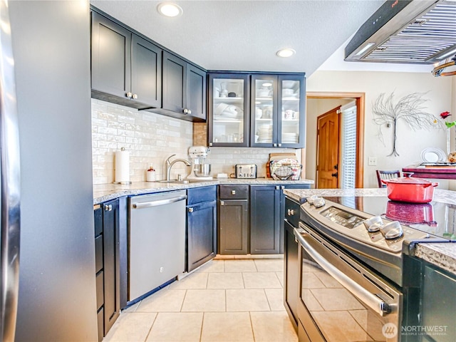 4425 65th St E, Tacoma, WA 98443 - kitchen with appliances with stainless steel finishes, extractor fan, light tile patterned floors, tasteful backsplash, and recessed lighting