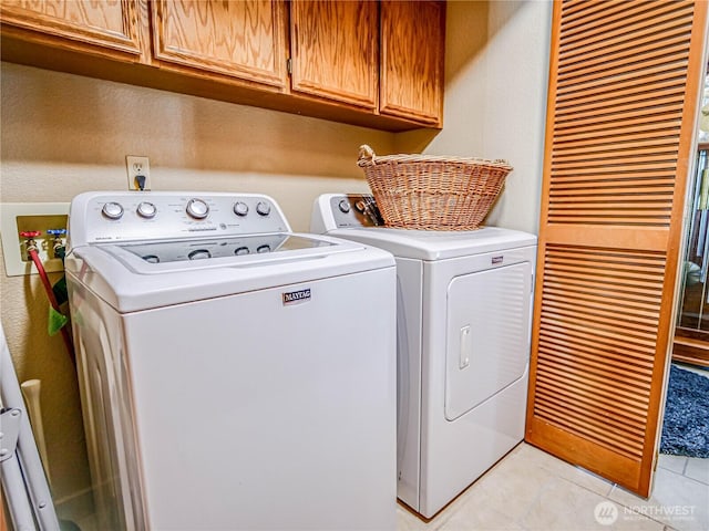 4425 65th St E, Tacoma, WA 98443 - laundry area with cabinet space, washer and dryer, and light tile patterned flooring