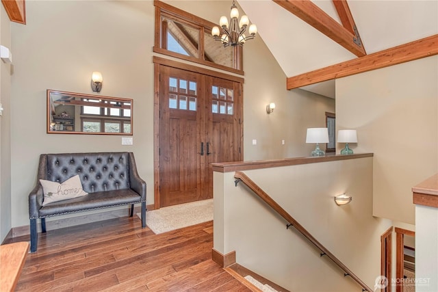 24386 US Highway 97, Chelan, WA 98816 - foyer featuring high vaulted ceiling, wood finished floors, a chandelier, beamed ceiling, and baseboards