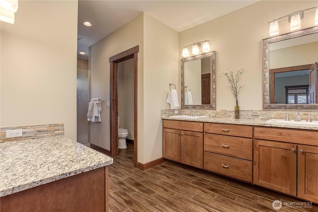 24386 US Highway 97, Chelan, WA 98816 - full bathroom with double vanity, backsplash, toilet, wood finished floors, and recessed lighting
