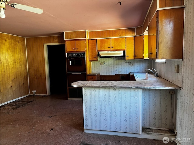 2405 Elmway, Okanogan, WA 98840 - kitchen featuring a sink, brown cabinets, a peninsula, under cabinet range hood, and a ceiling fan