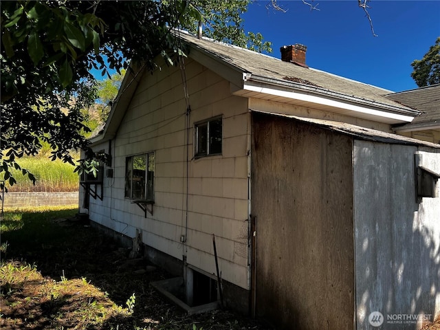 2405 Elmway, Okanogan, WA 98840 - view of side of property featuring a chimney and roof with shingles