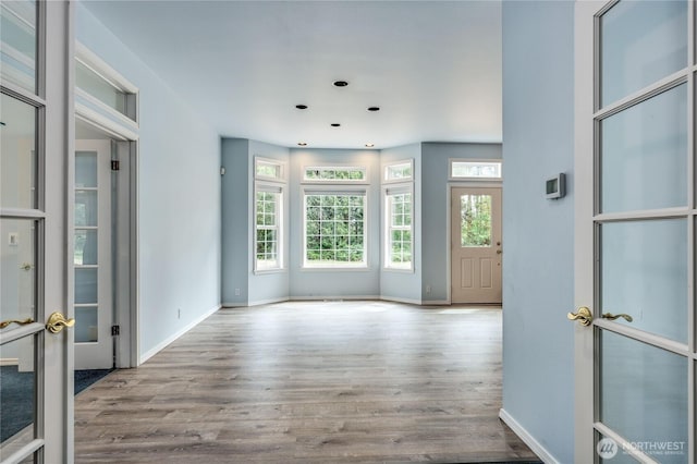 2800 Cliff St, Port Townsend, WA 98368 - empty room featuring healthy amount of natural light, wood finished floors, recessed lighting, and french doors