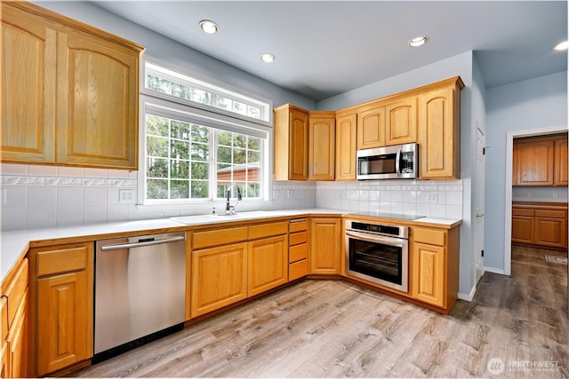 2800 Cliff St, Port Townsend, WA 98368 - kitchen with stainless steel appliances, light countertops, light wood finished floors, backsplash, and recessed lighting