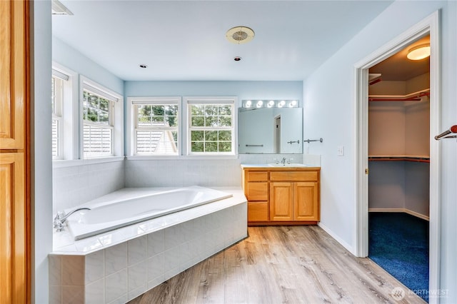 2800 Cliff St, Port Townsend, WA 98368 - bathroom with vanity, healthy amount of natural light, a bath, and wood finished floors