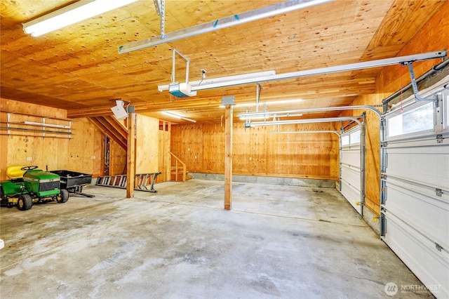 2800 Cliff St, Port Townsend, WA 98368 - garage featuring a garage door opener and wood walls