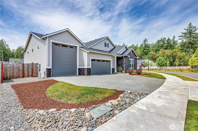 4689 Petrel St, Port Townsend, WA 98368 - view of front facade featuring an attached garage, stone siding, driveway, and roof with shingles