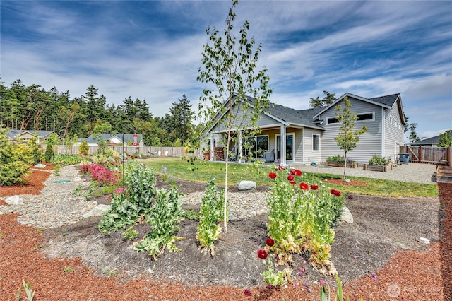 4689 Petrel St, Port Townsend, WA 98368 - view of front of property featuring a fenced backyard, a vegetable garden, and a patio