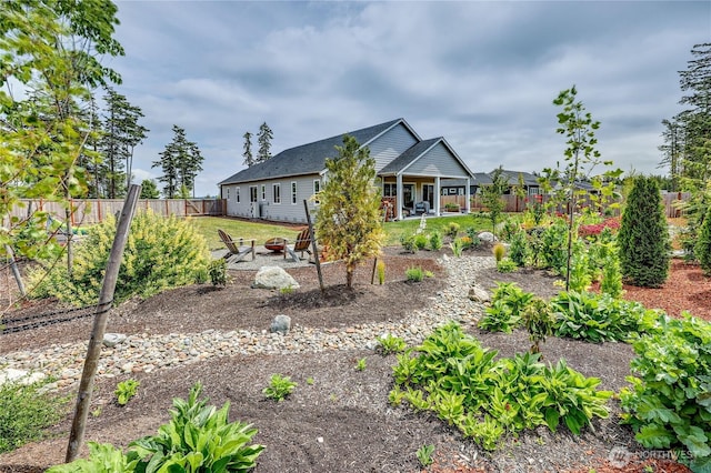 4689 Petrel St, Port Townsend, WA 98368 - rear view of house with a fire pit, a fenced backyard, and a patio area