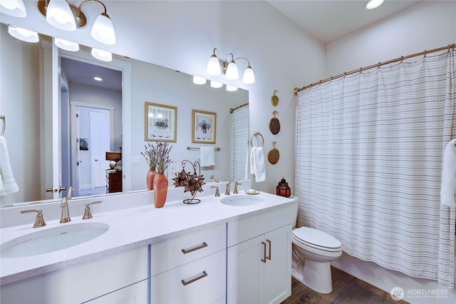4689 Petrel St, Port Townsend, WA 98368 - bathroom featuring double vanity, recessed lighting, wood finished floors, and shower / bath combo