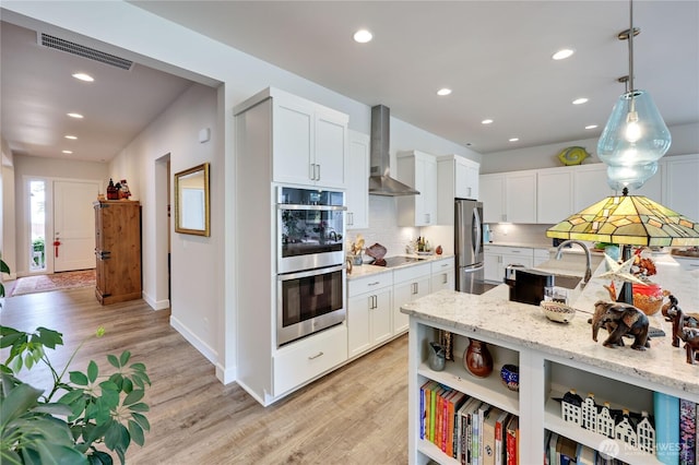 4689 Petrel St, Port Townsend, WA 98368 - kitchen with wall chimney exhaust hood, stainless steel appliances, decorative backsplash, open shelves, and white cabinetry