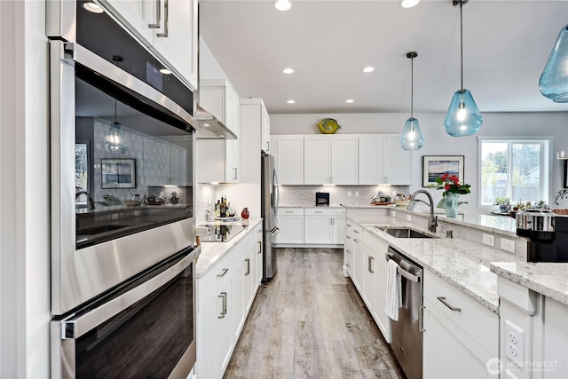 4689 Petrel St, Port Townsend, WA 98368 - kitchen with stainless steel appliances, tasteful backsplash, white cabinets, recessed lighting, and light stone countertops