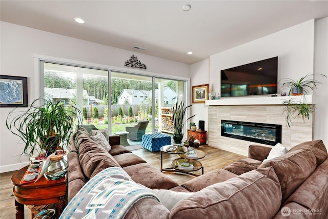 4689 Petrel St, Port Townsend, WA 98368 - living area with wood finished floors, a tiled fireplace, and recessed lighting