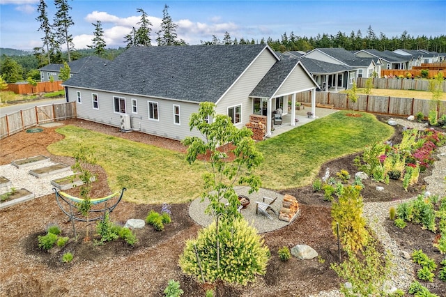 4689 Petrel St, Port Townsend, WA 98368 - rear view of house featuring a patio, roof with shingles, a residential view, and a fenced backyard