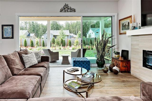 4689 Petrel St, Port Townsend, WA 98368 - living room featuring a tiled fireplace and wood finished floors