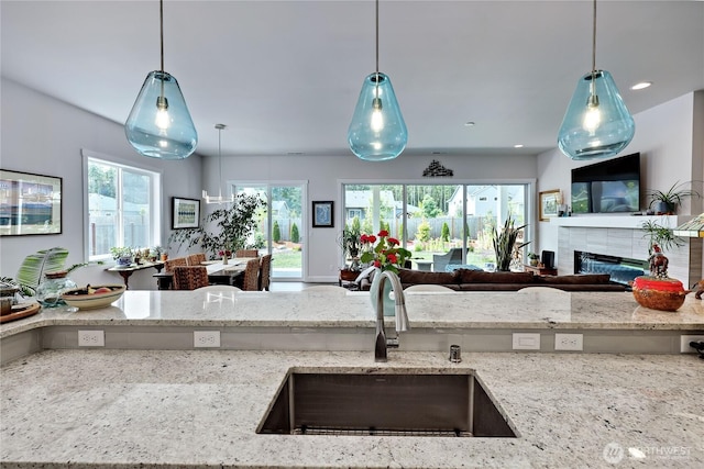 4689 Petrel St, Port Townsend, WA 98368 - kitchen with open floor plan, light stone countertops, a fireplace, plenty of natural light, and recessed lighting