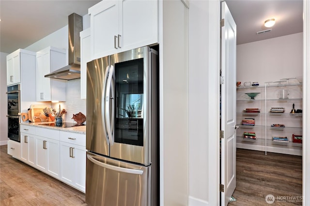 4689 Petrel St, Port Townsend, WA 98368 - kitchen with black appliances, wall chimney exhaust hood, light wood-style flooring, and white cabinets