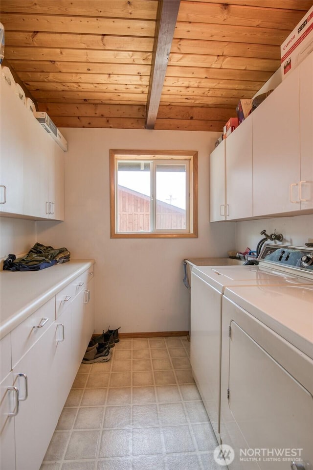 1211 E Market St, Aberdeen, WA 98520 - laundry room with wood ceiling, cabinet space, washing machine and dryer, light floors, and baseboards