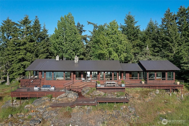 2000 Mount Dallas Rd, Friday Harbor, WA 98250 - view of front of home with a metal roof, a deck, and a chimney