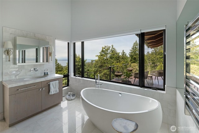 2000 Mount Dallas Rd, Friday Harbor, WA 98250 - bathroom featuring vanity, a soaking tub, healthy amount of natural light, and tile walls