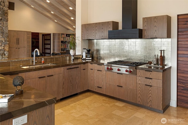 2000 Mount Dallas Rd, Friday Harbor, WA 98250 - kitchen with wall chimney range hood, stainless steel gas cooktop, high vaulted ceiling, tasteful backsplash, and recessed lighting