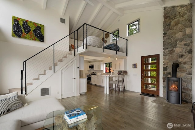 2000 Mount Dallas Rd, Friday Harbor, WA 98250 - living area with high vaulted ceiling, stairway, dark wood finished floors, a wood stove, and healthy amount of natural light
