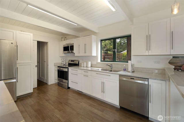 2000 Mount Dallas Rd, Friday Harbor, WA 98250 - kitchen with stainless steel appliances, white cabinets, dark wood-type flooring, light stone countertops, and a wood ceiling with exposed beams