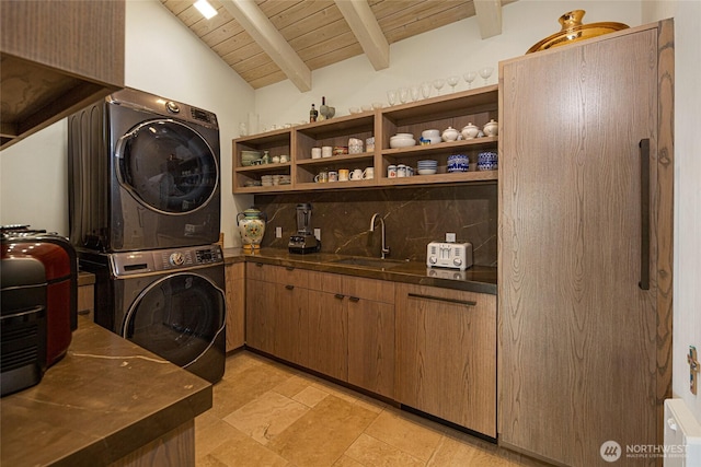 2000 Mount Dallas Rd, Friday Harbor, WA 98250 - laundry room with stacked washer and clothes dryer, cabinet space, wood ceiling, and light stone finish flooring