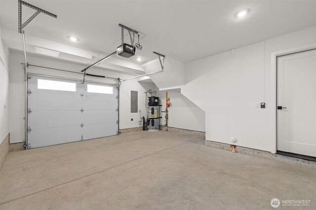 11232 Corliss Ave N, Seattle, WA 98133 - garage featuring electric panel, hybrid water heater, a garage door opener, and recessed lighting