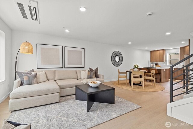 11232 Corliss Ave N, Seattle, WA 98133 - living room featuring stairs, light wood finished floors, and recessed lighting