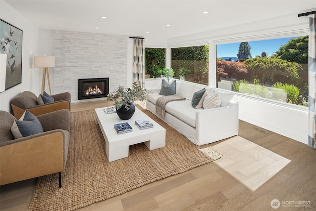 1910 Edgemont Pl W, Seattle, WA 98199 - living area featuring wood finished floors, a stone fireplace, and recessed lighting