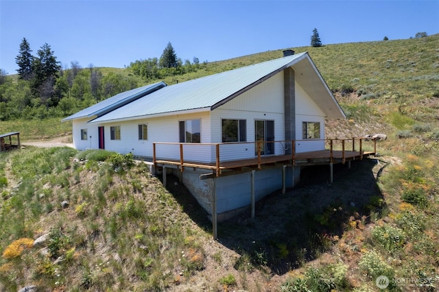 427 Rendezvous Rd, Winthrop, WA 98862 - rear view of property with a wooden deck and a metal roof