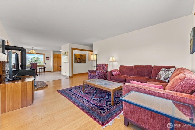427 Rendezvous Rd, Winthrop, WA 98862 - living room featuring light wood finished floors and a wood stove