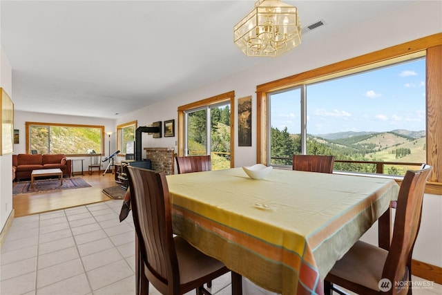 427 Rendezvous Rd, Winthrop, WA 98862 - dining area featuring a mountain view, light tile patterned floors, and a chandelier