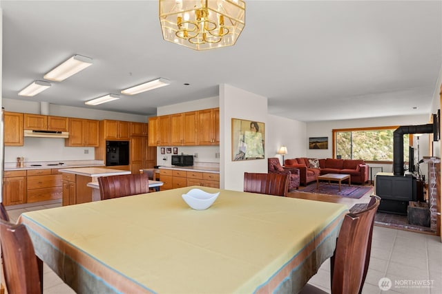 427 Rendezvous Rd, Winthrop, WA 98862 - dining room with a wood stove, light tile patterned floors, and a chandelier