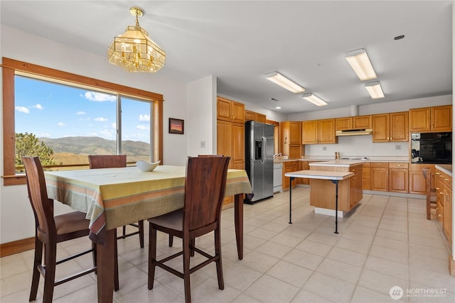 427 Rendezvous Rd, Winthrop, WA 98862 - dining room featuring a chandelier, a mountain view, and light tile patterned floors