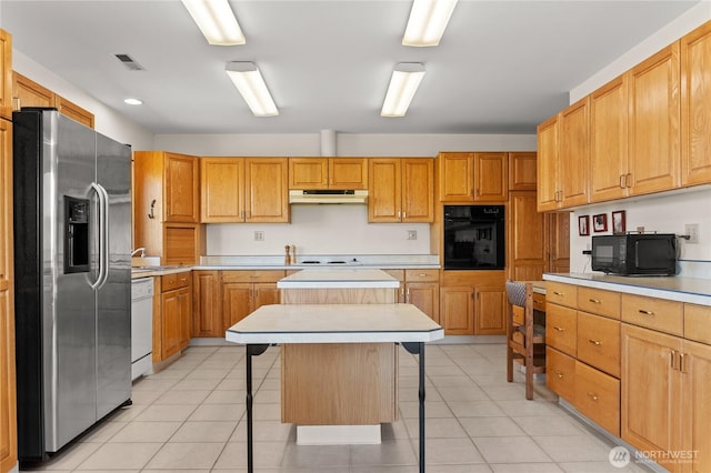 427 Rendezvous Rd, Winthrop, WA 98862 - kitchen with black appliances, under cabinet range hood, a kitchen island, a breakfast bar area, and light countertops