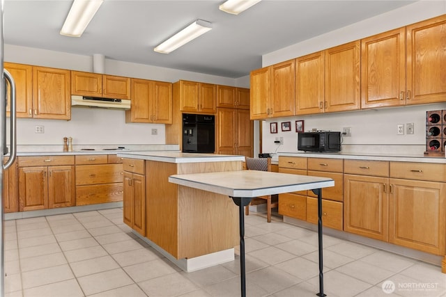 427 Rendezvous Rd, Winthrop, WA 98862 - kitchen featuring black appliances, light countertops, under cabinet range hood, a center island, and a kitchen breakfast bar