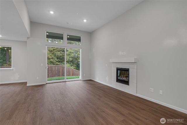 2605 S 7th Way, Ridgefield, WA 98642 - unfurnished living room featuring dark wood finished floors, a fireplace, baseboards, and recessed lighting