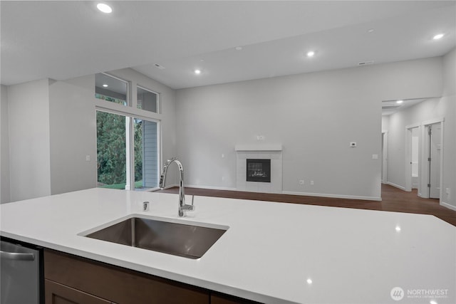 2605 S 7th Way, Ridgefield, WA 98642 - kitchen with a sink, light countertops, open floor plan, recessed lighting, and a tiled fireplace