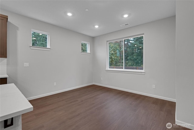 2605 S 7th Way, Ridgefield, WA 98642 - unfurnished dining area featuring dark wood-style flooring, plenty of natural light, recessed lighting, and baseboards