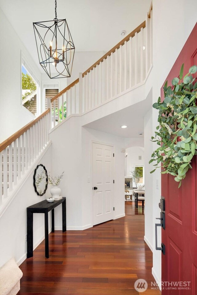 4213 249th Ct SE, Sammamish, WA 98029 - entryway with a chandelier, wood finished floors, a high ceiling, stairway, and arched walkways