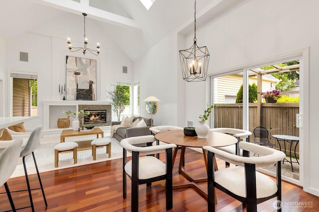 4213 249th Ct SE, Sammamish, WA 98029 - dining room featuring a chandelier, high vaulted ceiling, dark wood finished floors, a glass covered fireplace, and beam ceiling