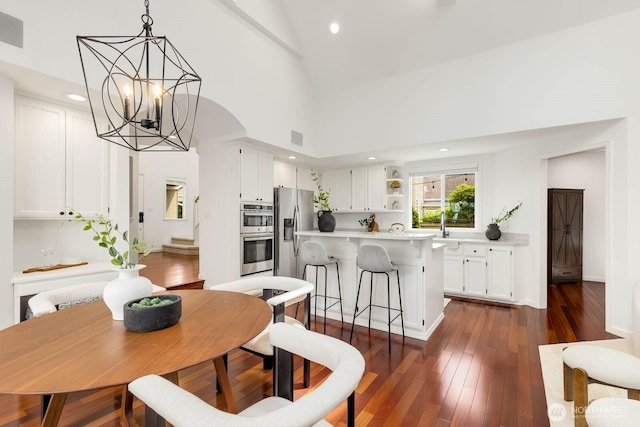 4213 249th Ct SE, Sammamish, WA 98029 - dining space with a chandelier, recessed lighting, dark wood-style flooring, and high vaulted ceiling