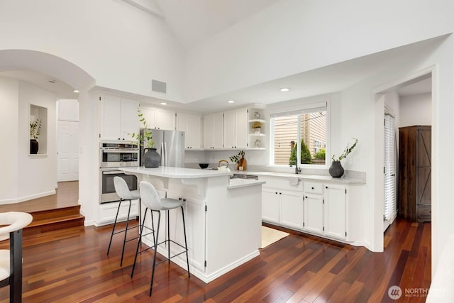 4213 249th Ct SE, Sammamish, WA 98029 - kitchen featuring appliances with stainless steel finishes, light countertops, open shelves, white cabinetry, and a kitchen island
