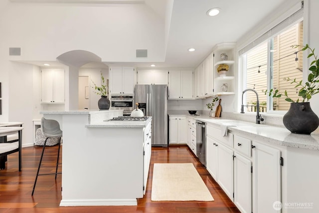 4213 249th Ct SE, Sammamish, WA 98029 - kitchen featuring appliances with stainless steel finishes, a center island, white cabinetry, light stone counters, and recessed lighting